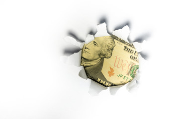 United States Dollar Currency through a ripped paper.
