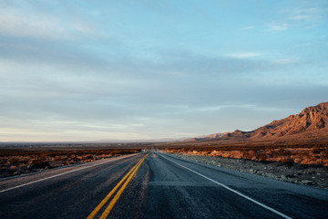 Fototapeta na wymiar Desert Road at Sunset in the New Mexico Organ Mountains