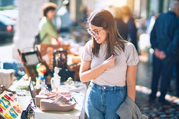 Young beautiful woman smiling happy and confident. Standing with smile on face looking a jumble...
