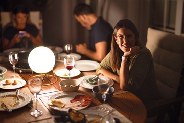 Beautiful family on dinner talking and smiling at terrace