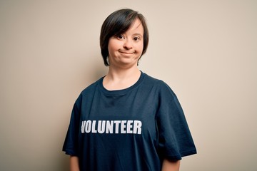 Young down syndrome volunteer woman wearing social care charity t-shirt with a happy and cool smile on face. Lucky person.