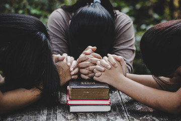Group of different women praying together