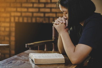 Girl while praying for christian religion.