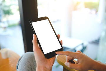 Close up of man using cell phone,sending massages on the coffee shop with black screen,texting,video calls.