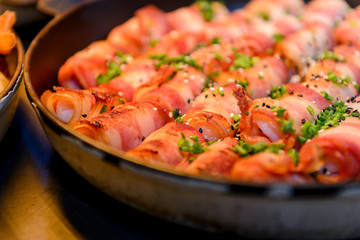 Prawn wrapped with bacon and rosemary. baked appetizer. Close-up shot.