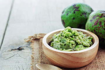 Avocado in bowl on floor.