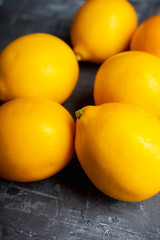 Fresh ripe lemons on the rustic background. Selective focus. Shallow depth of field.