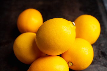 Fresh ripe lemons on the rustic background. Selective focus. Shallow depth of field.