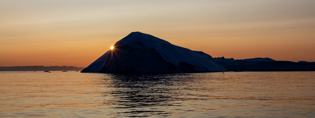 Golden sun in Disko Bay, Ilulissat Icefjord, Greenland