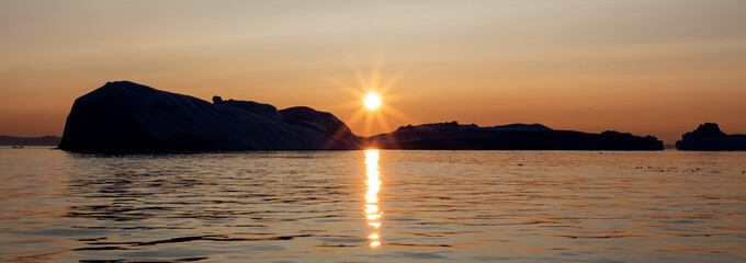Golden sun in Disko Bay, Ilulissat Icefjord, Greenland