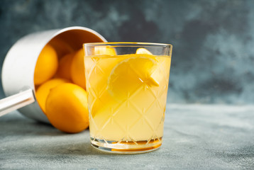 Old fahioned lemon beverage on the rustic background. Selective focus. Shallow depth of field.