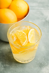 Old fahioned lemon beverage on the rustic background. Selective focus. Shallow depth of field.