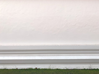 grasses on the floor with white wall texture.