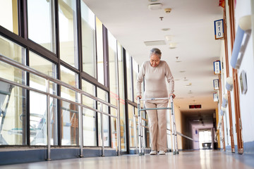 asian old woman exercising by walking using a walker