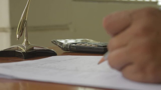 Human hand calculating business finance investment report using calculator - adding machine tape. Business finance and industry, accountancy concepts. Close up.