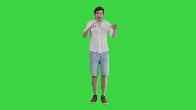 Man in summer outfir telling a story emotionaly on a Green Screen, Chroma Key.
