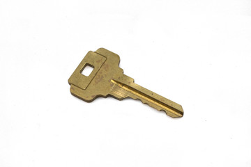 A brass house key, close up, isolated on a clean, white background.  Shot in macro.