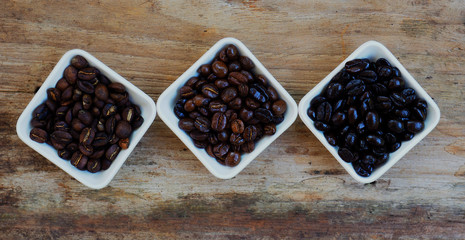 black coffee and coffee beans on wood background pea burry