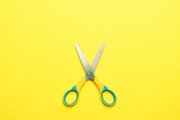 scissor on yellow background. copy space. flat lay