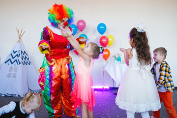 Children play with a clown