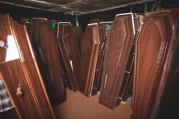 Wooden coffins in the dark room.