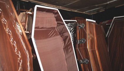 Wooden coffins in the dark room.