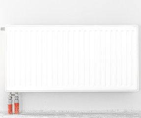 Radiator in front of a white wall. Space for text.