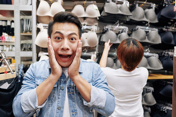 Young Asian man lost his mind waiting for his girlfriend searching for the perfect nude bra