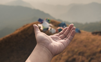 Hands outstretched to receive natural light and mountain views, beautiful morning fog. hipster style.