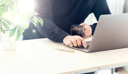 E-learning concept. Man sit at desk look at pc screen listened information or conducts online...