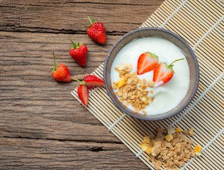 Top view strawberry yogurt and fresh strawberry on wooden white background.