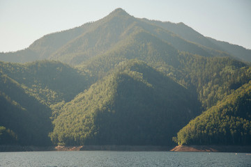 the concept of boating, recreation, travel - splashes of blue water in the river, mountains, sky,...