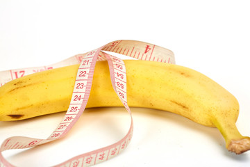 Ruler, banana and condom on jeans 