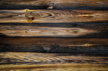 Old pine horizontal boards. The wood texture is brown-yellow with rings and traces of knots. Wooden abstract background, structure.
