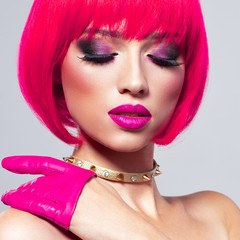 Model with creative colored bob hairstyle. Girl in leather gloves. Glamour fashion model with bright make-up