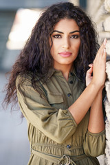 Young Arab Woman with curly hair outdoors - obrazy, fototapety, plakaty