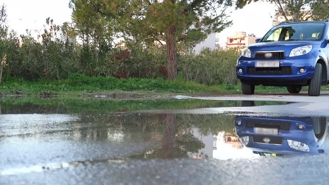 Motorcycle and skateboard passing over the water with reflaction and splashes.