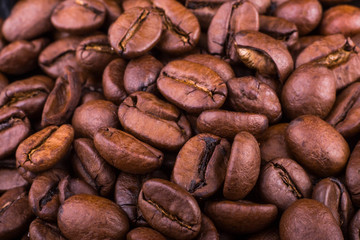 close-up texture and background of brown roasted aromatic coffee