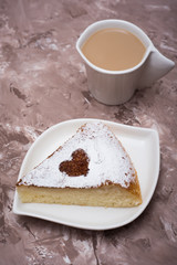 Coffee and a piece of powdered powdered cake.