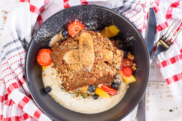 Two slices of Banana Bread on a bed of Tahini Yoghurt with grilled bananas and summer fruits