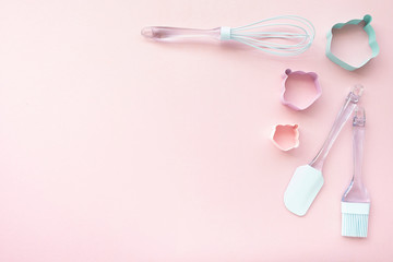 Mix backing utensils on pink background, top view, copy space