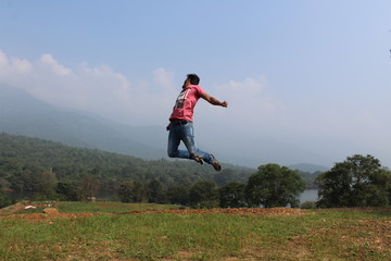 girl jumping on a meadow