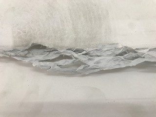 Grayscale of fragile and torn polyurethane rubber tip.