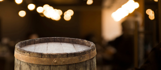 Wooden barrel on a table and textured background