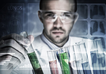 Portrait of concentrated male scientist working with reagents in laboratory