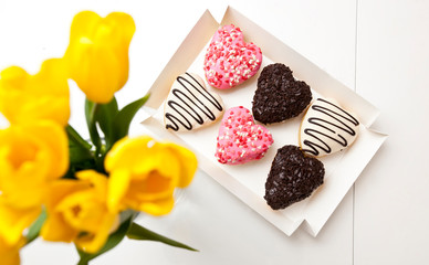 Six delicious donuts in shape of the heart on the wooden table