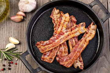 Closeup of slices of crispy hot fried bacon