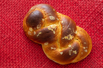 Sweet bread, easter greek tsoureki braid on red background