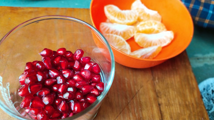 pomegranate and juice in glass on wooden table