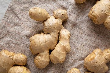 Raw Organic Ginger Root on cloth, top view. Flat lay, from above, overhead.
